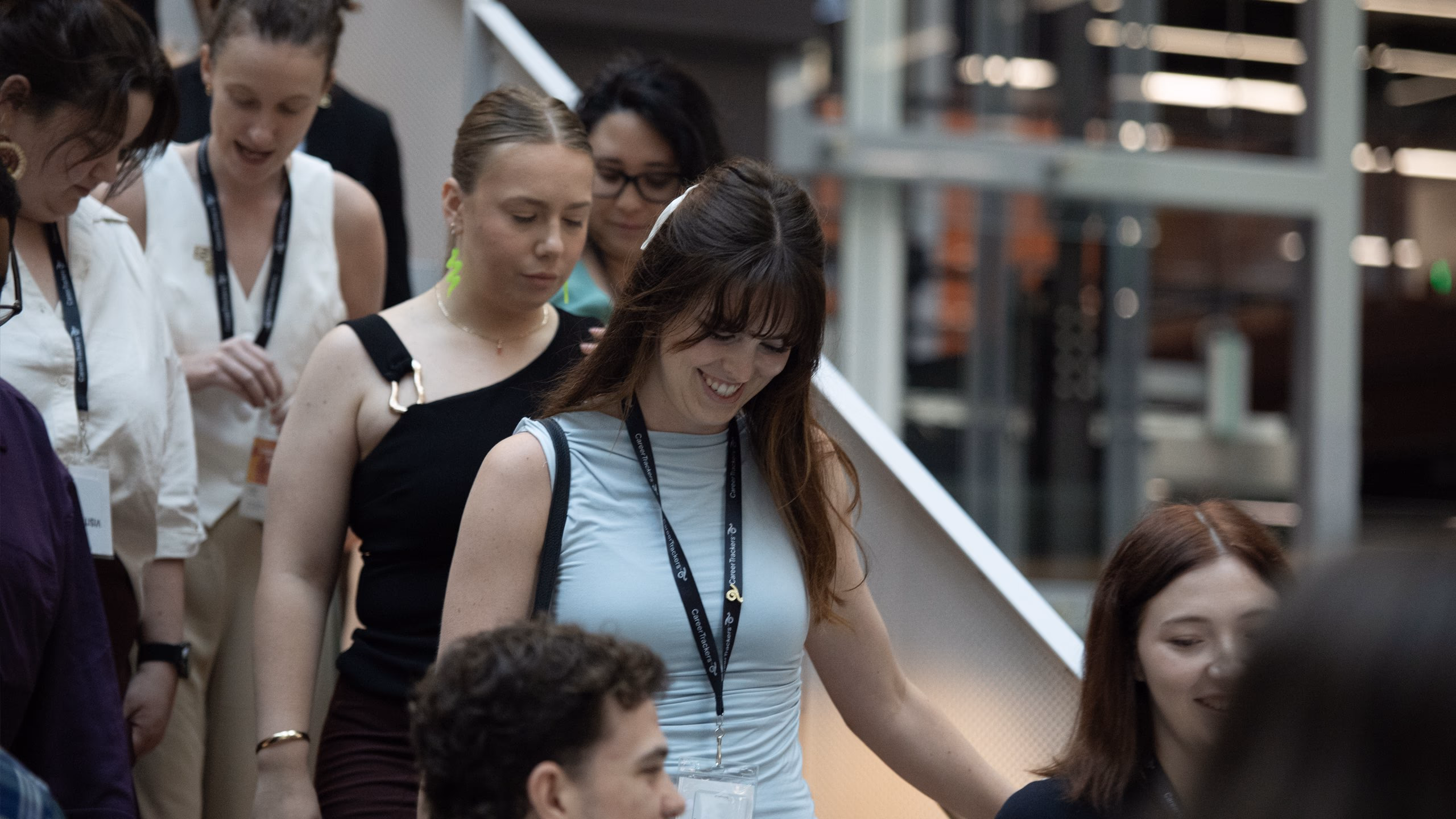 CareerTrackers alumni gathered together, smiling and connecting at a community event.