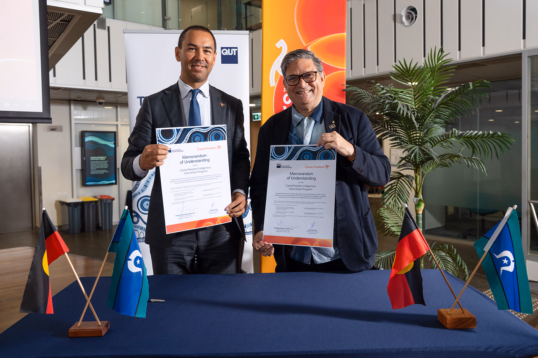 CareerTrackers and QUT representatives signing the renewed Memorandum of Understanding