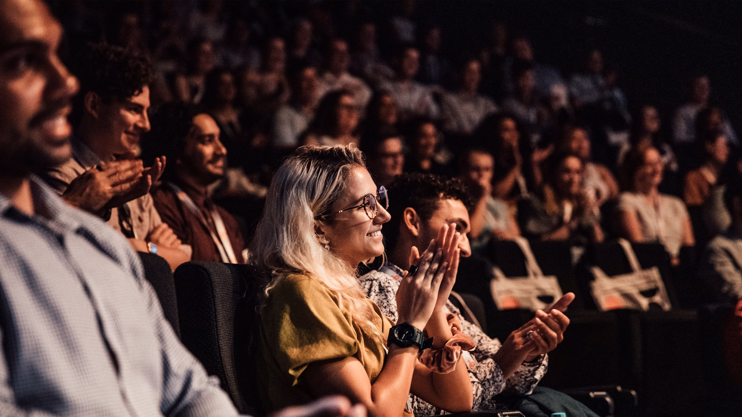 A crowd applauding at a CareerTrackers event.